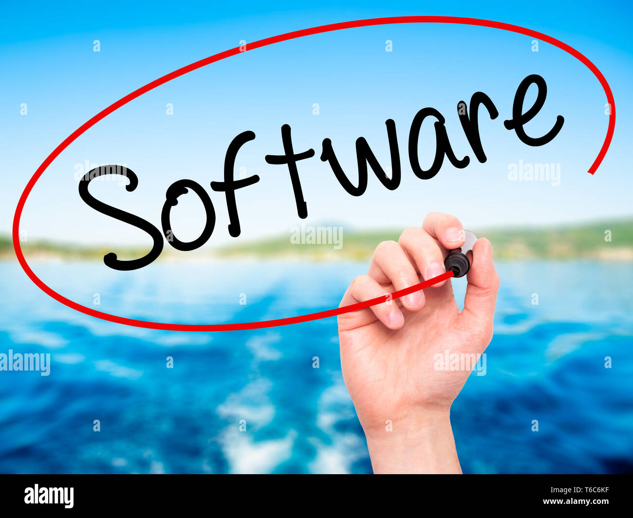 Man Hand writing Software  with black marker on visual screen. Stock Photo
