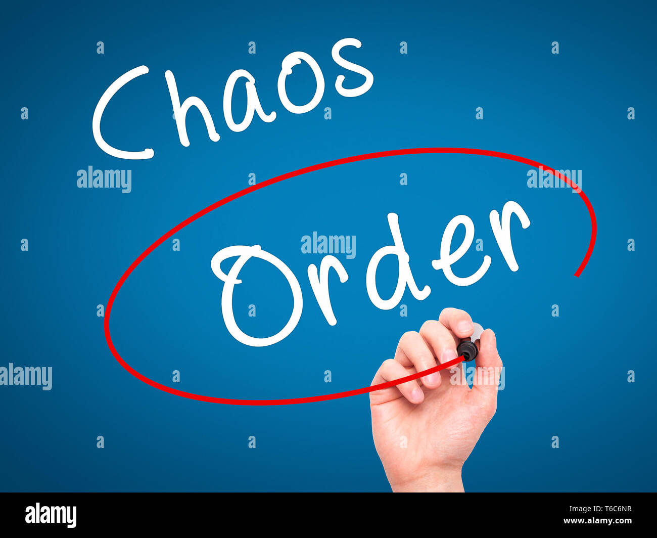 Man Hand writing and Choosing Order instead of Chaos with black marker on visual screen Stock Photo