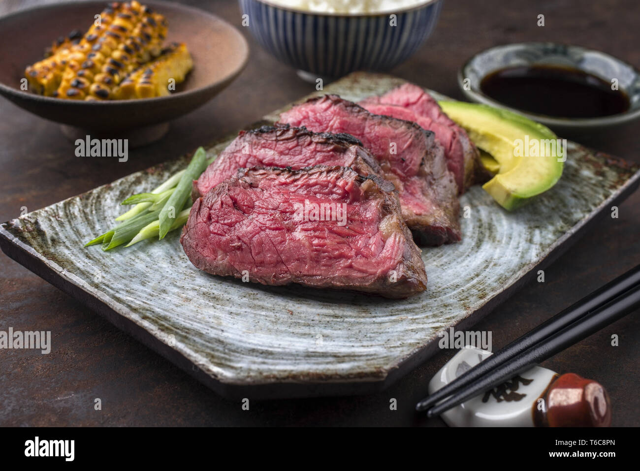 Japanese Kobe Steak Fillet with Rice and Avocado as close-up on a ...