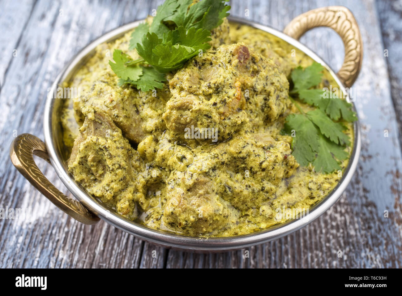 Traditional Indian Lamb Curry with Mint and Coriander as closeup in a