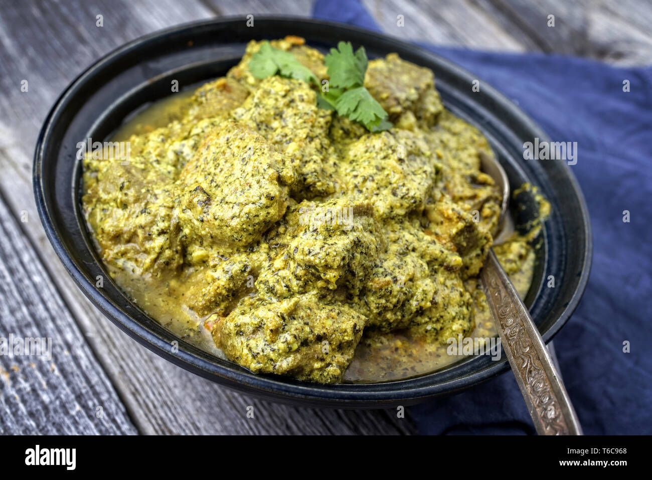 Traditional Indian Lamb Curry with Mint and Coriander as closeup in a