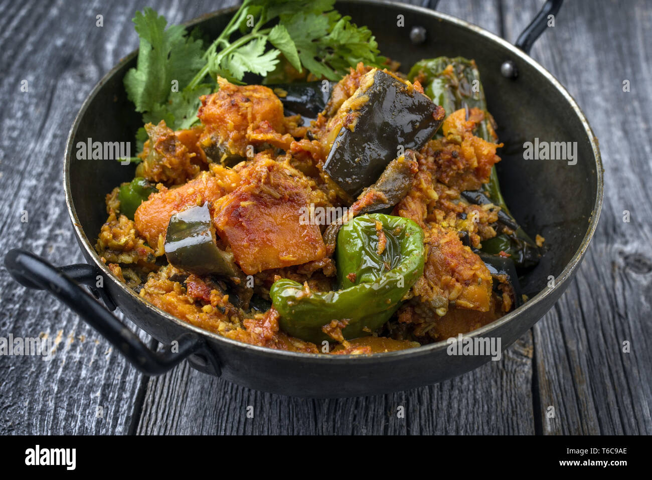 Indian Vegetable Curry Fry with Sweet Potatos and Eggplant as closeup in a Korai Stock Photo