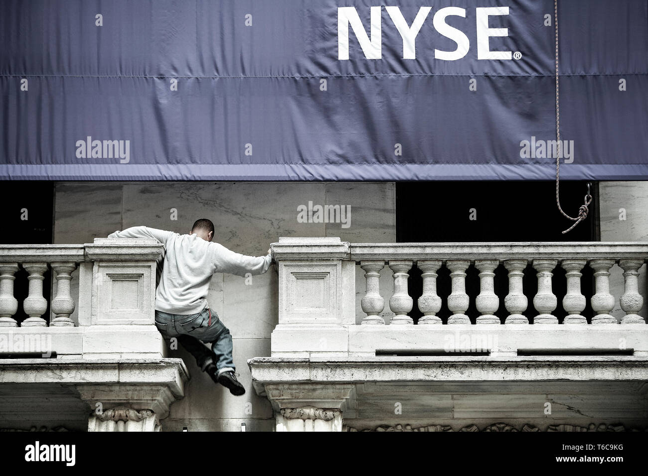 NYSE Stock Exchange the day after the bail-out package was rejected in the House. A NYSE worker does some balancing 15 feet above ground. Stock Photo