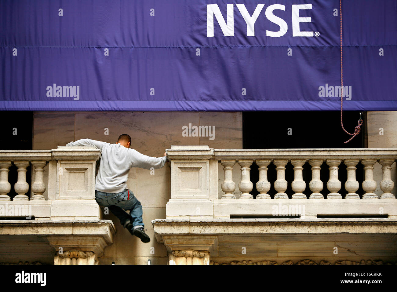 NYSE Stock Exchange the day after the bail-out package was rejected in the House. A NYSE worker does some balancing 15 feet above ground. Stock Photo