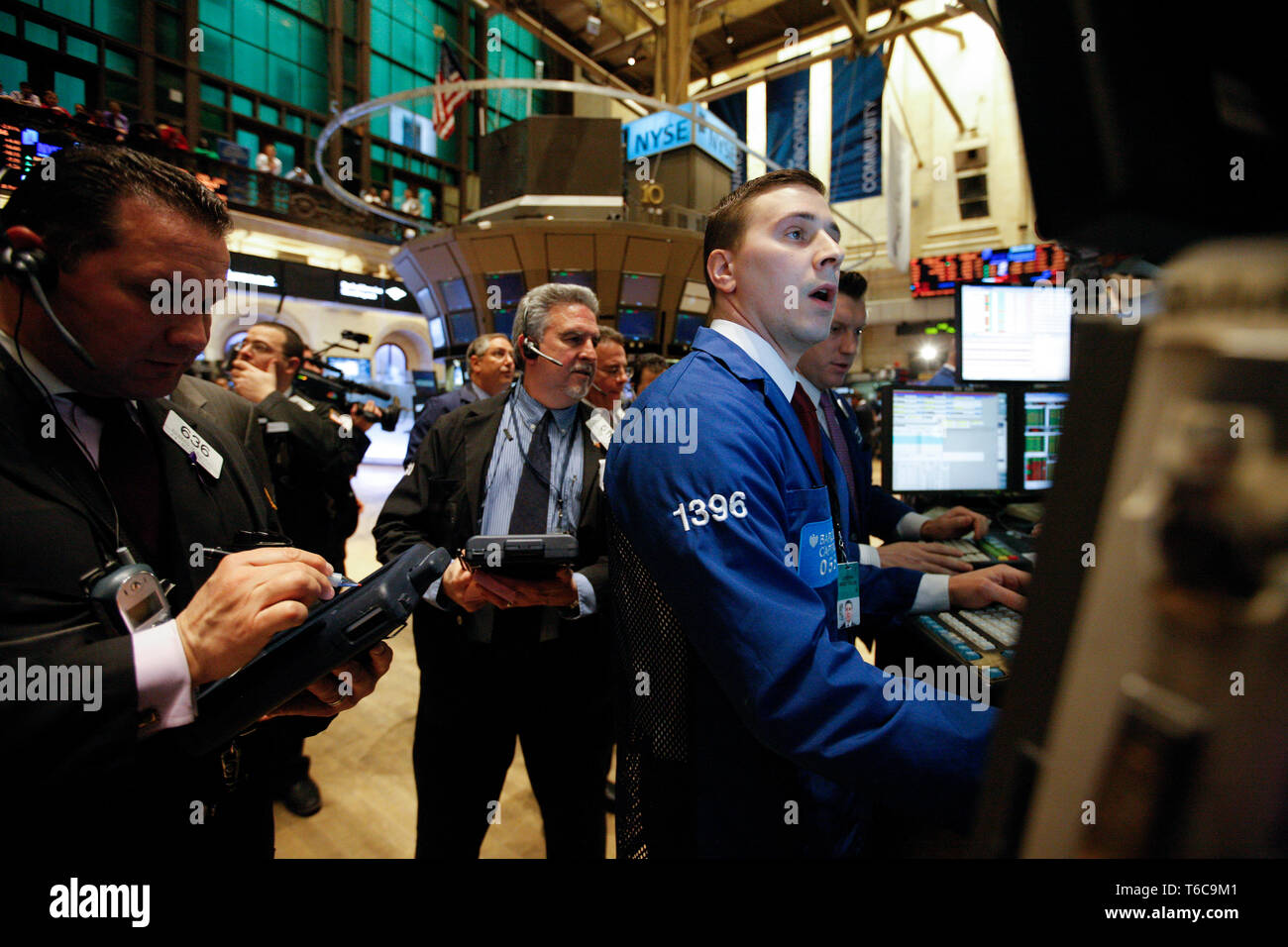 Floor specialists trade on the NYSE Euronext Stock Exchange. The NYSE New York Stock Exchange reacts nervously to the dire news from Japan. Stock Photo