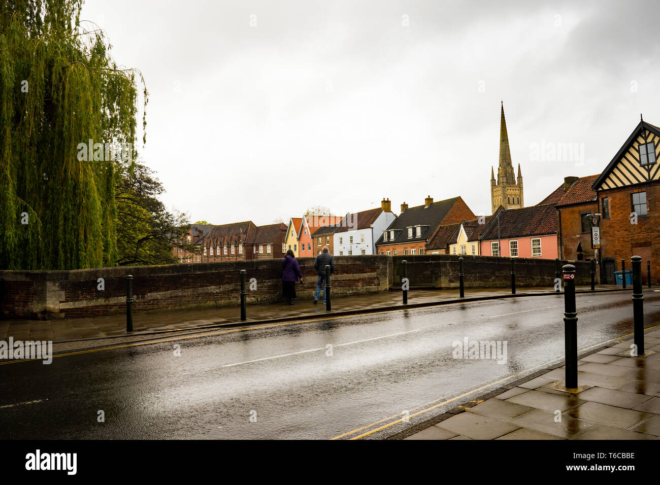 A couple stop on Fye Bridge in Magdalen Street, Norwich and look at the