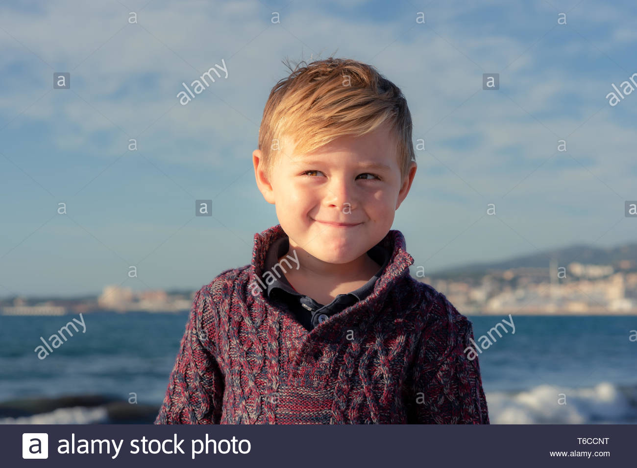Cute Little Boy With Blonde Hair And A Cheeky Smile Looks To One Side Half Lenght Portrait With Sea Sky And City Background Stock Photo Alamy Cute Little Boy With Blonde Hair And A Cheeky Smile Looks To One Side Half Lenght Portrait With Sea Sky And City Background Stock Photo Alamy