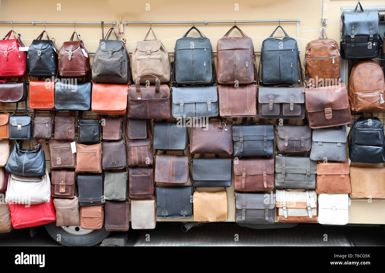 many leather bags displayed for sale at a market stall Stock Photo