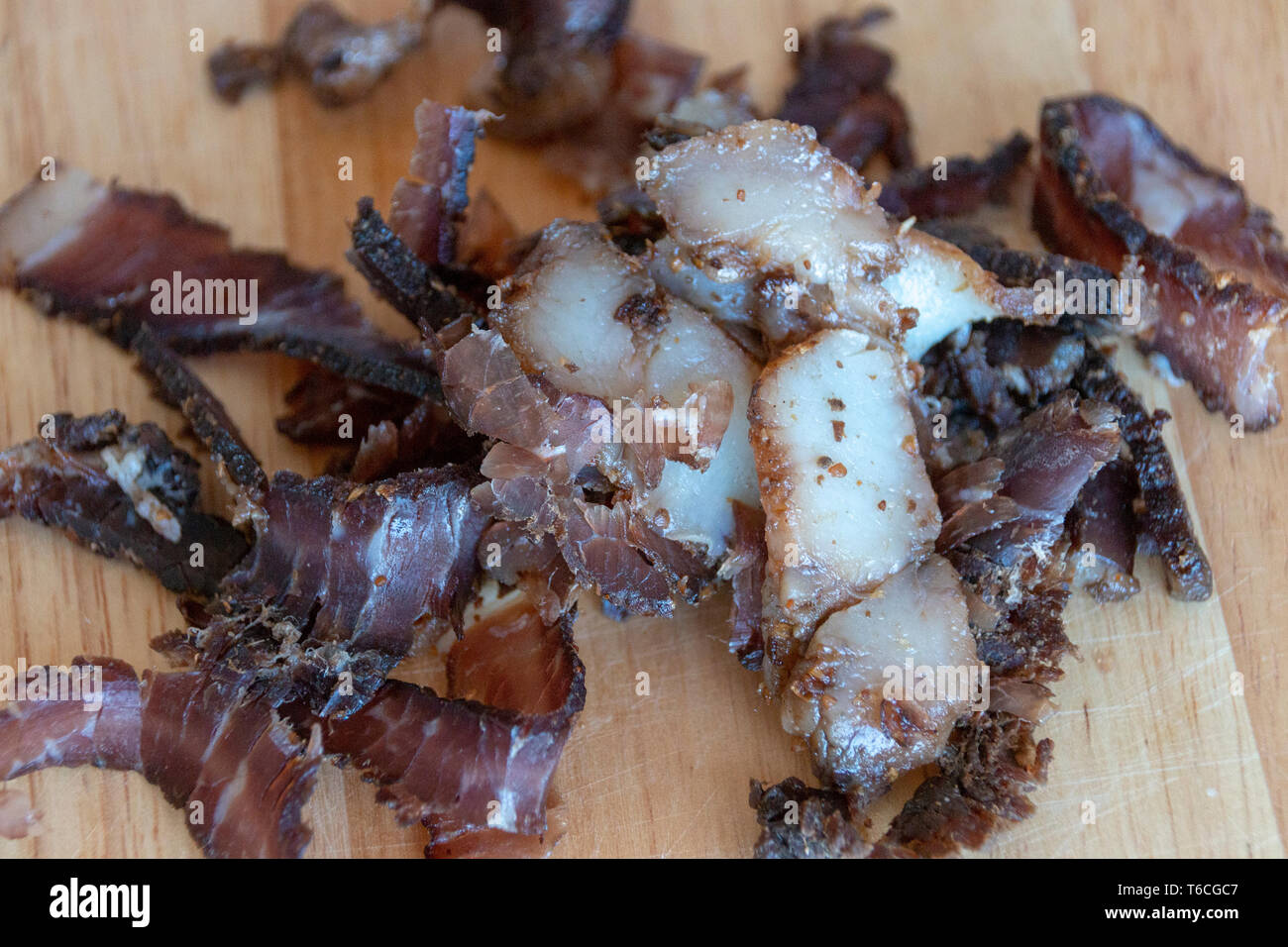 A close up view of a pile of south african biltong on a wood cutting board Stock Photo