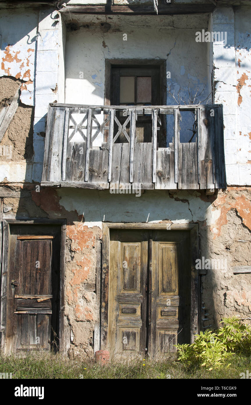 Old abandoned grunge rural house facade Stock Photo