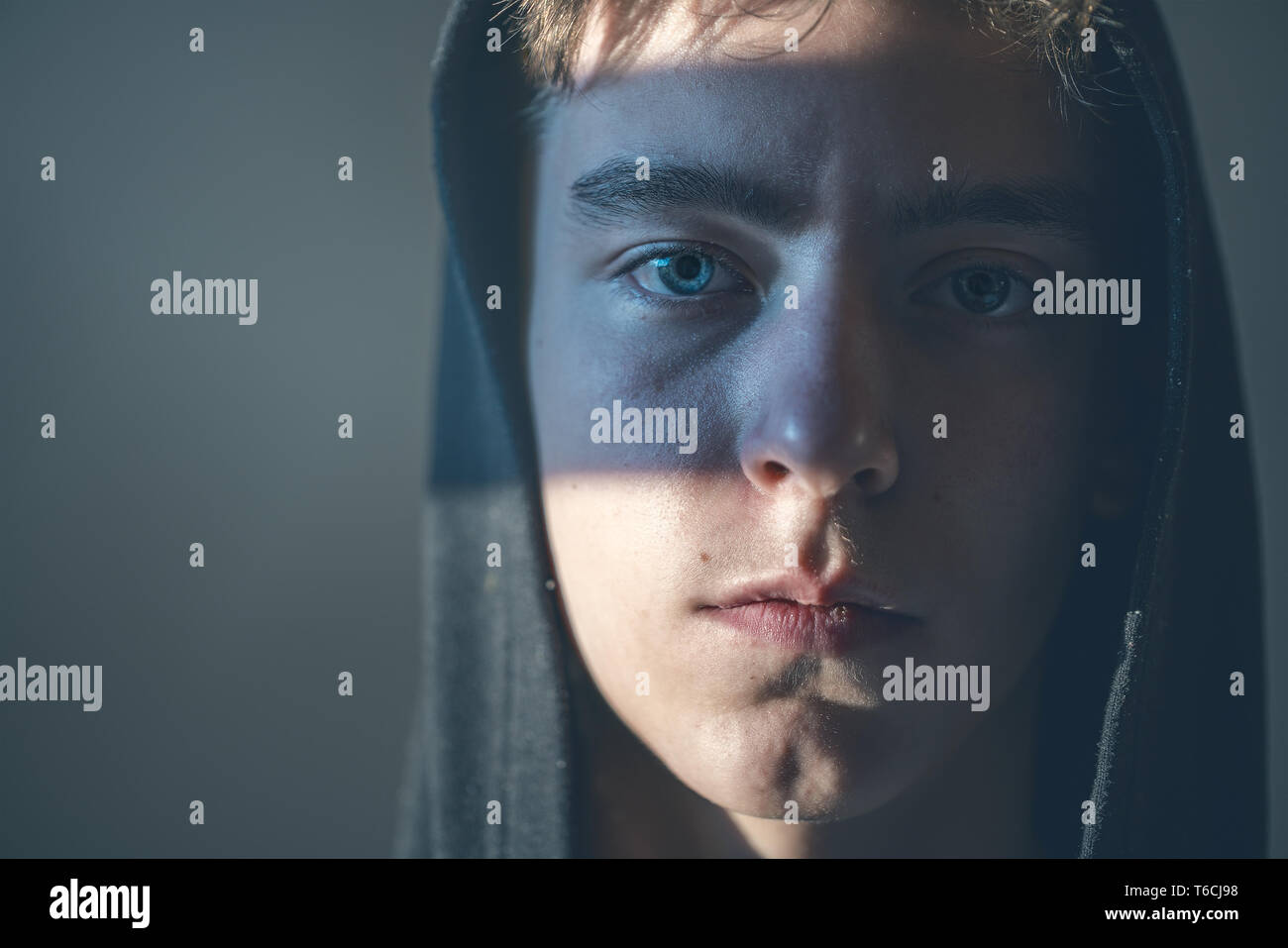 close up portrait of a young man with hoodie Stock Photo