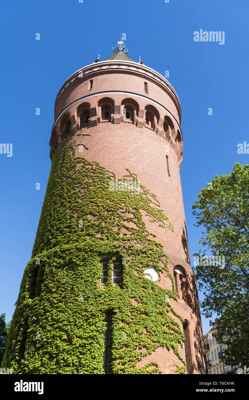 old water tower overgrown with ivy in Berlin Kreuzberg Stock Photo