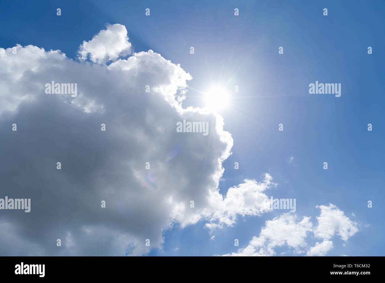 cloudscape with blue sky and sun for backgrounds Stock Photo - Alamy