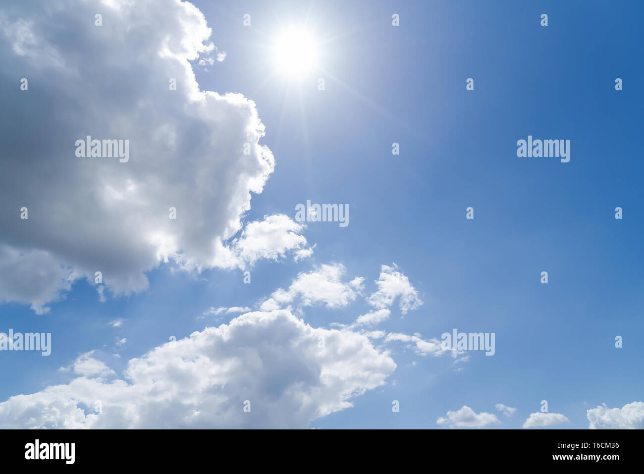 cloudscape with blue sky and sun for backgrounds Stock Photo - Alamy