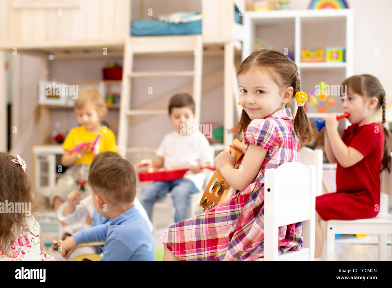 Music lesson in primary school. Kids group playing musical instruments