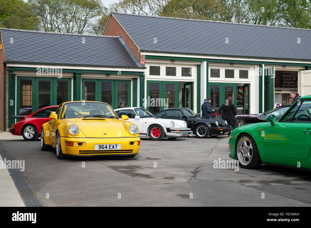 Porsche cars in front of a garage at Bicester heritage centre. Bicester, Oxfordshire, England Stock Photo
