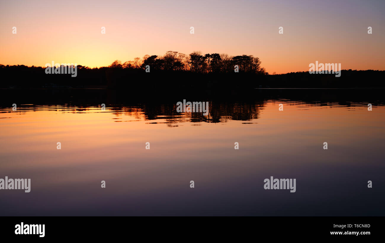 Tranquil lake sunset reflects hi-res stock photography and images - Alamy