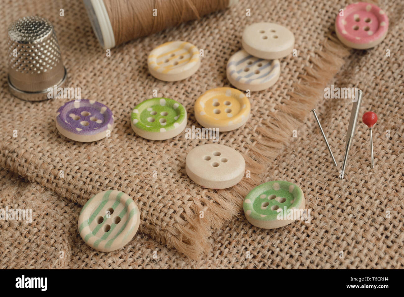 Wooden buttons with stripes of colored colors on a rustic fabric ...