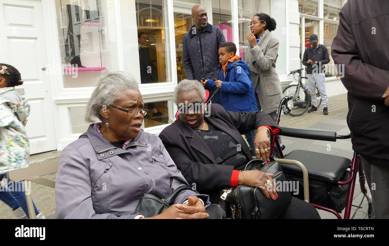 Two old black (Caribbean) ladies seated on a bench resting. London Stock Photo