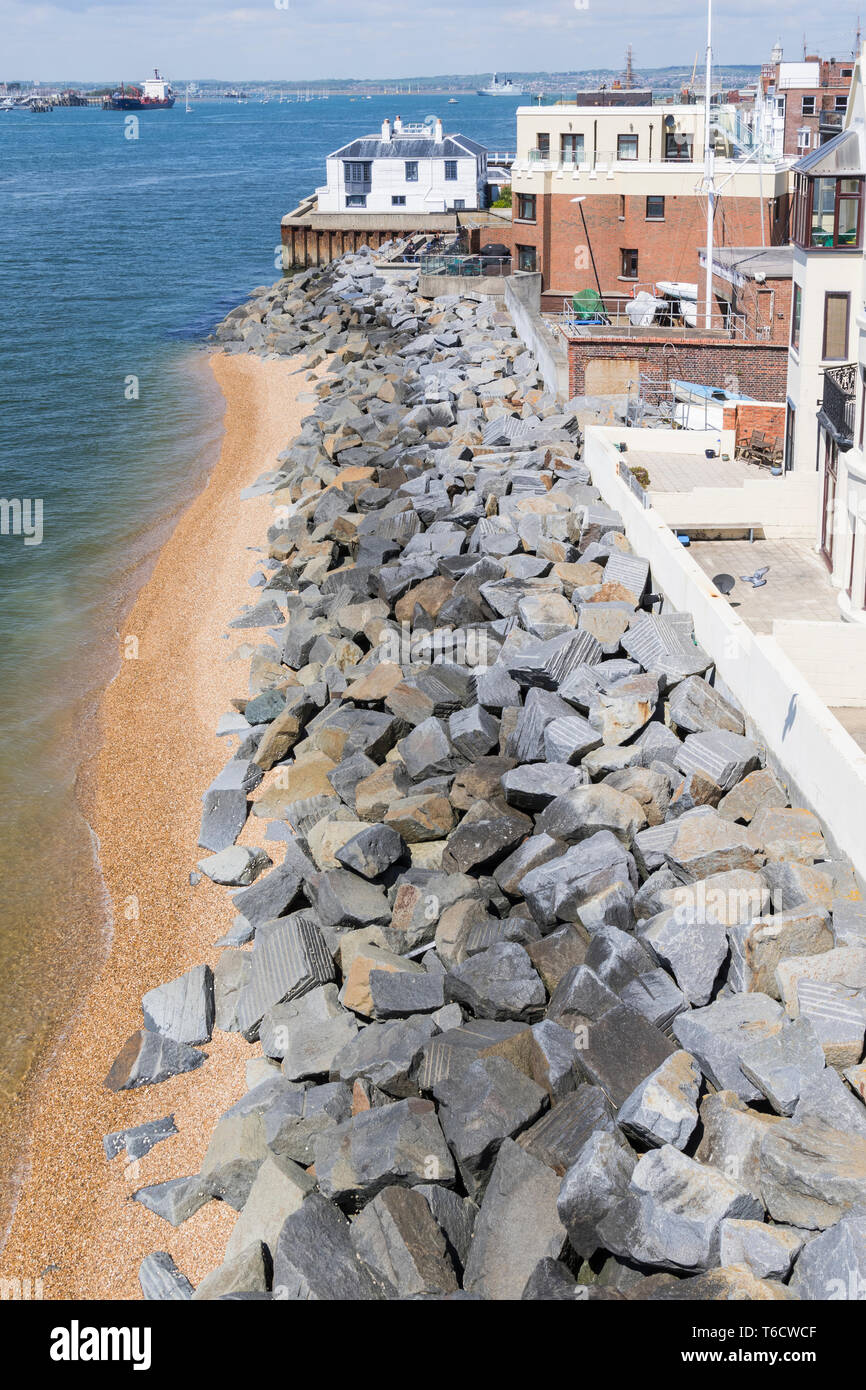 Large boulders on a beach used as sea defence to protect from flooding in Old Portsmouth, Hampshire, England, UK. Sea defences. Stock Photo