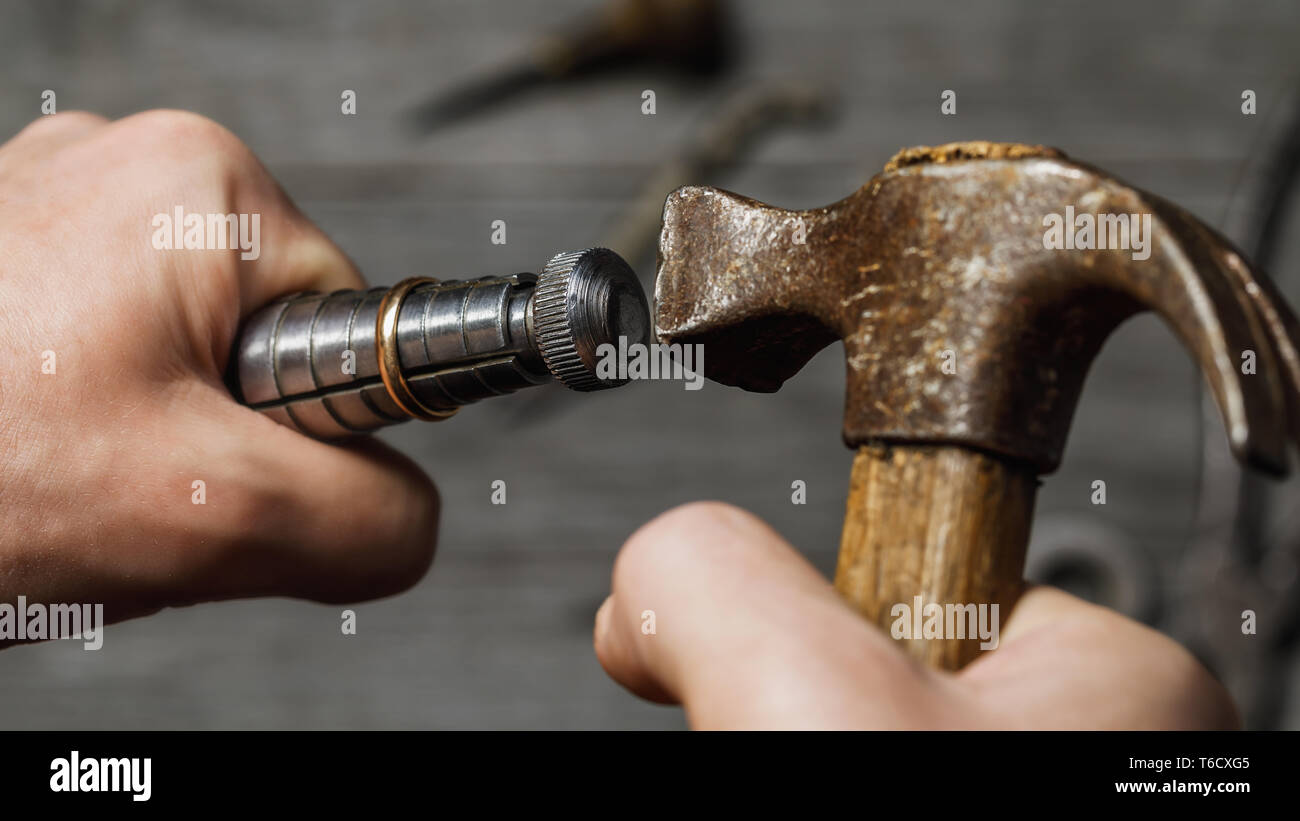 Jeweler increases the size of the gold ring, a close-up of the workflow Stock Photo