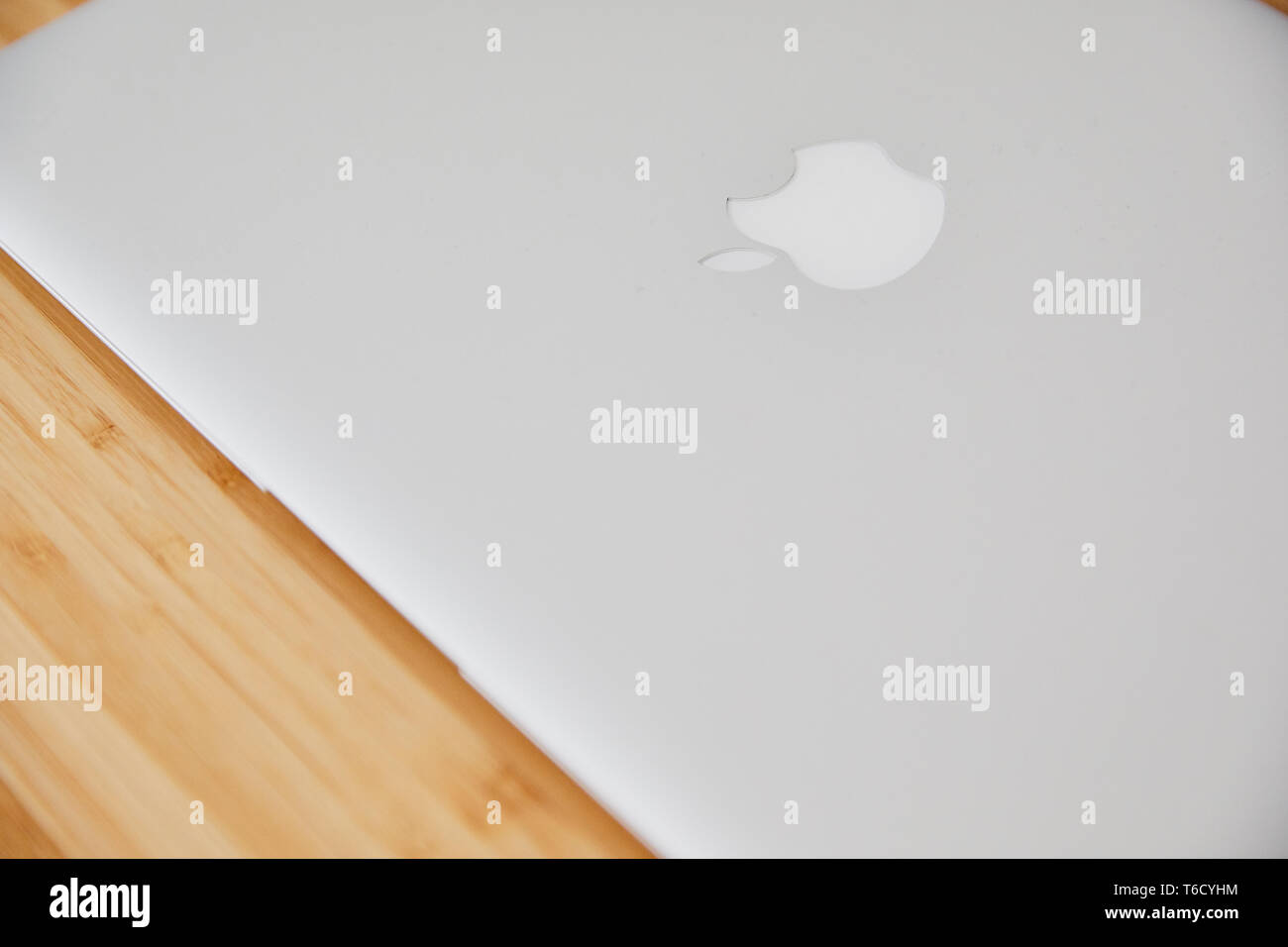 Apple Macbook Air notebook close on the wooden bamboo desk Stock Photo