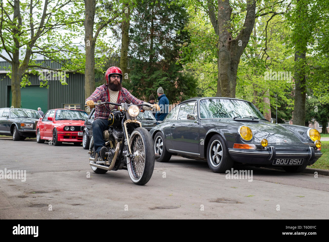 Biker riding a custom Harley Davidson motorcycle at the Bicester Heritage Centre 'Drive It Day'. Bicester, Oxfordshire, England Stock Photo