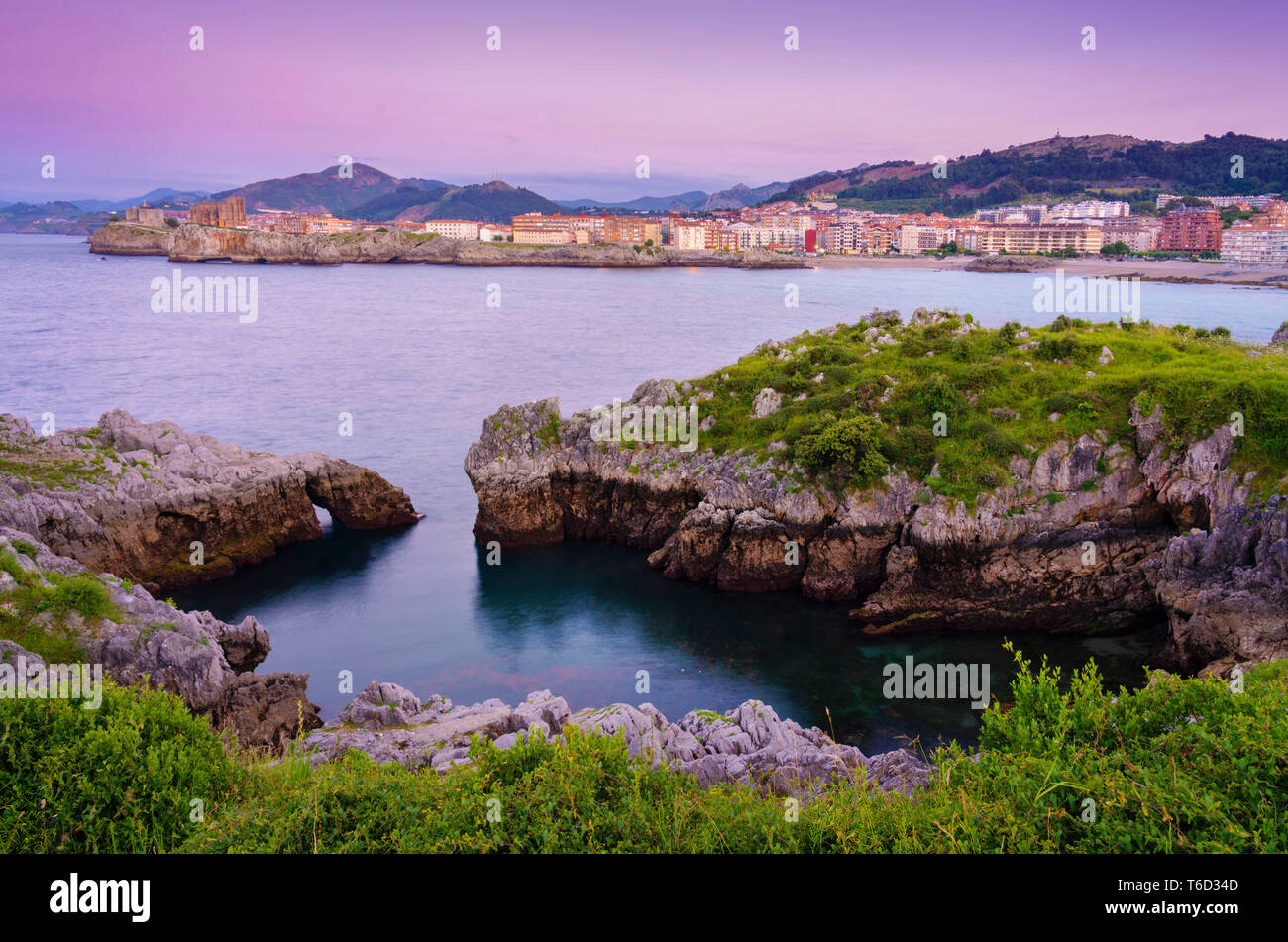 Spain, Cantabria, Castro-Urdiales, view of town and horseshoe cove at dusk Stock Photo