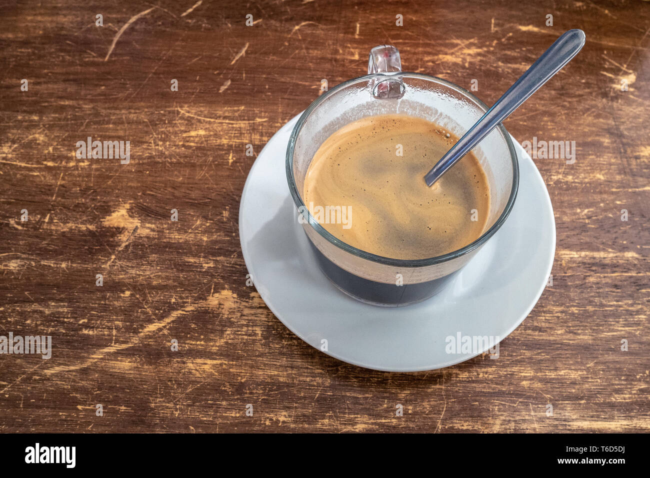 Cafe Cubano in in a glass mug on a wooden table Stock Photo