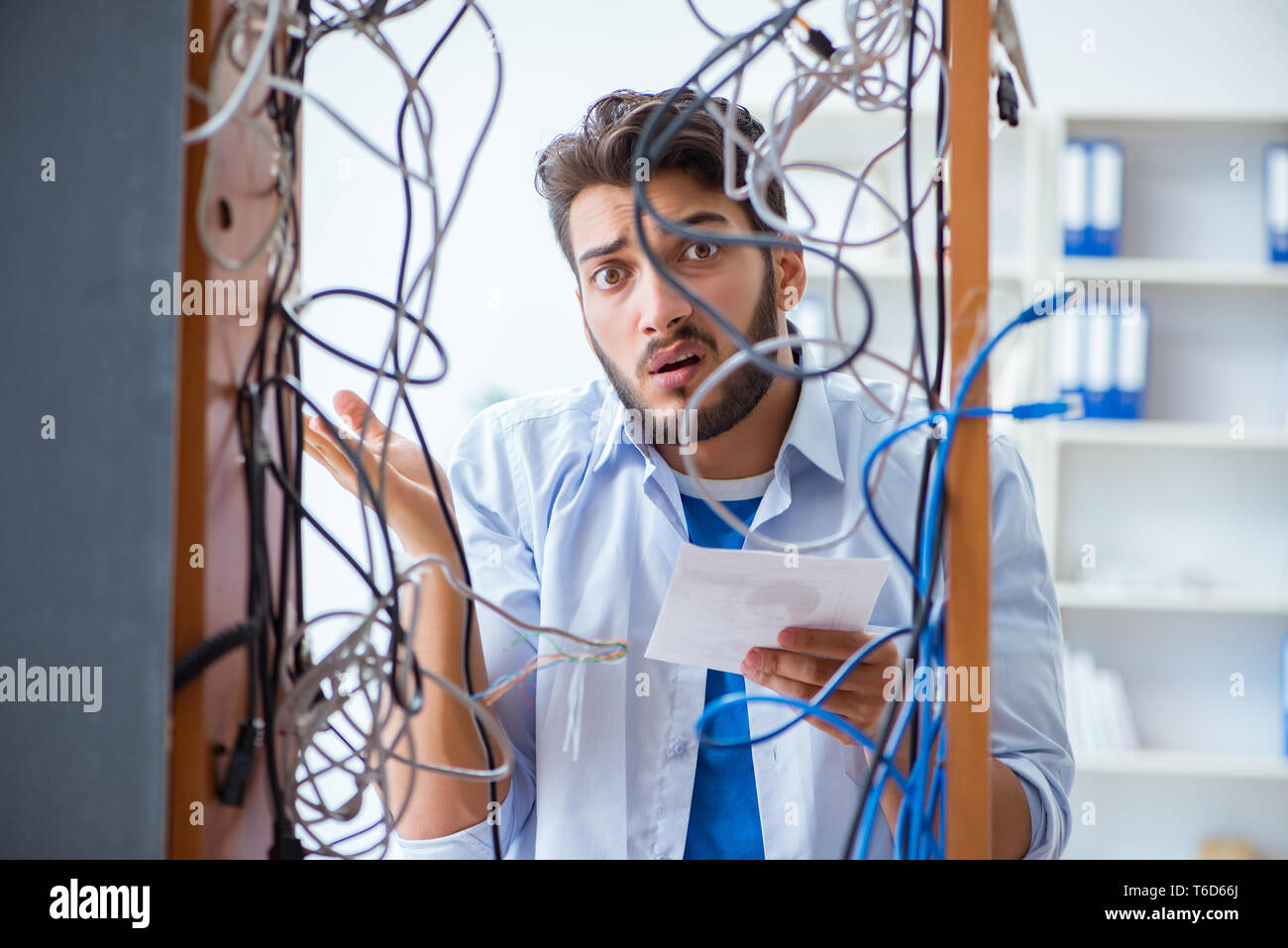 Computer repairman working on repairing network in IT workshop Stock Photo