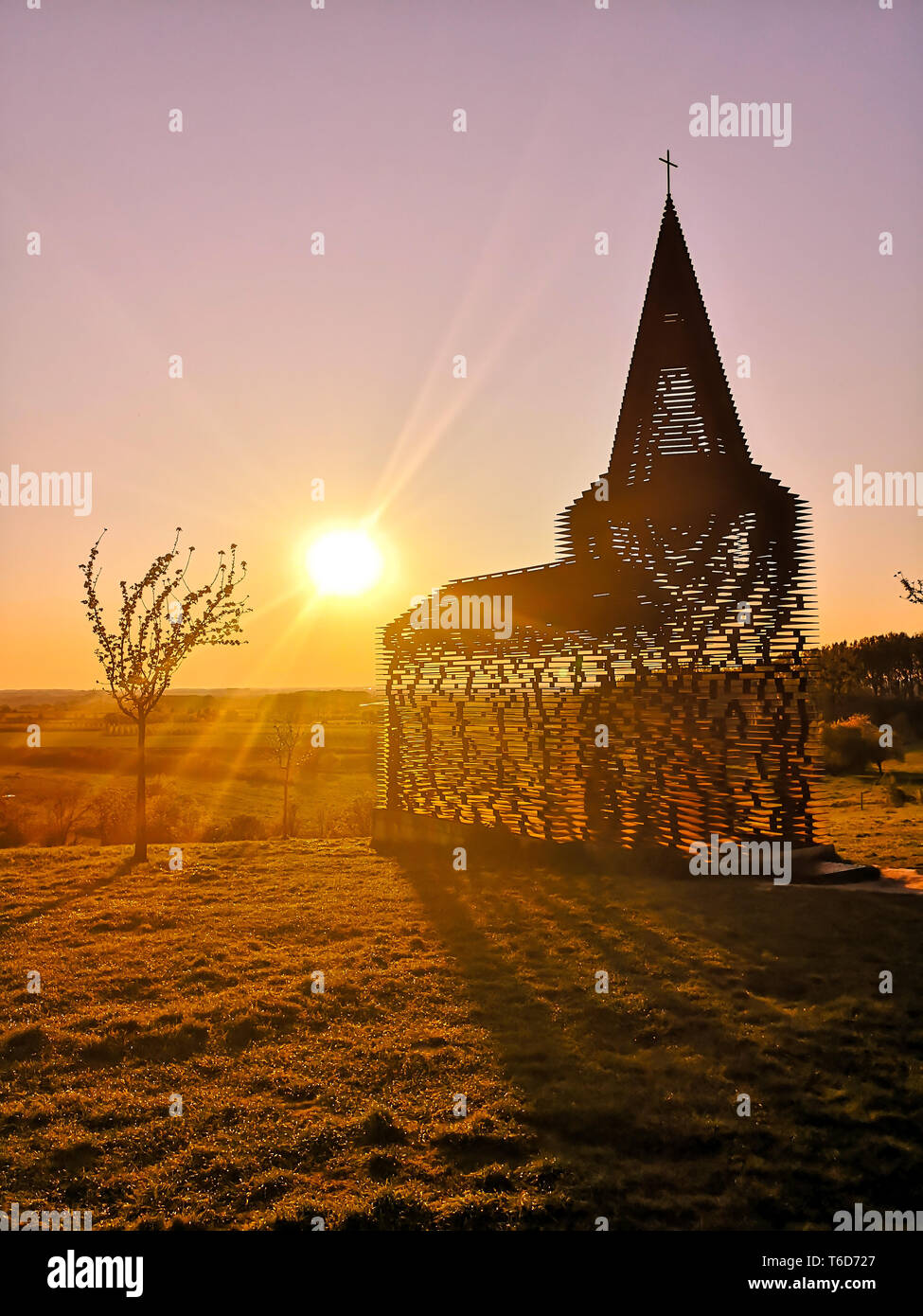 BORGLOON, BELGIUM - APRIL 2019: Art project and landmark qteel see-through church by Gijs Van Vaerenbergh called Reading Between the Lines at sunset Stock Photo