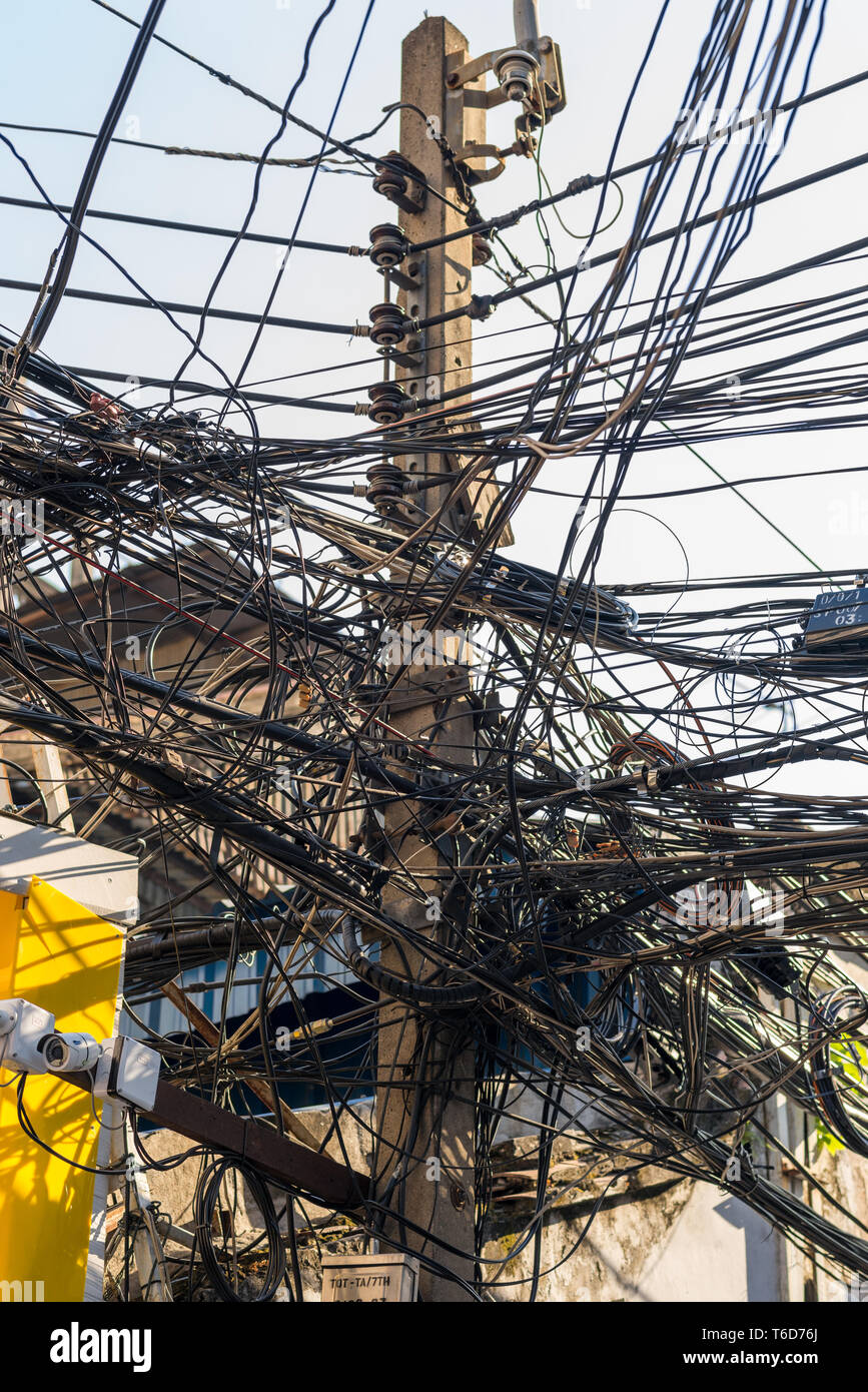 Overhead cable laid on utility pole, Bangkok Chinatown Stock Photo