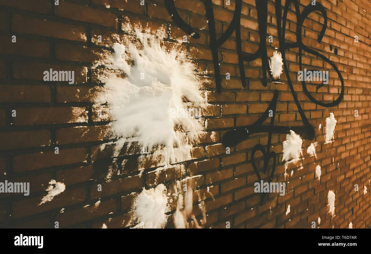snowball hitting a brick wall with graffiti Stock Photo Alamy