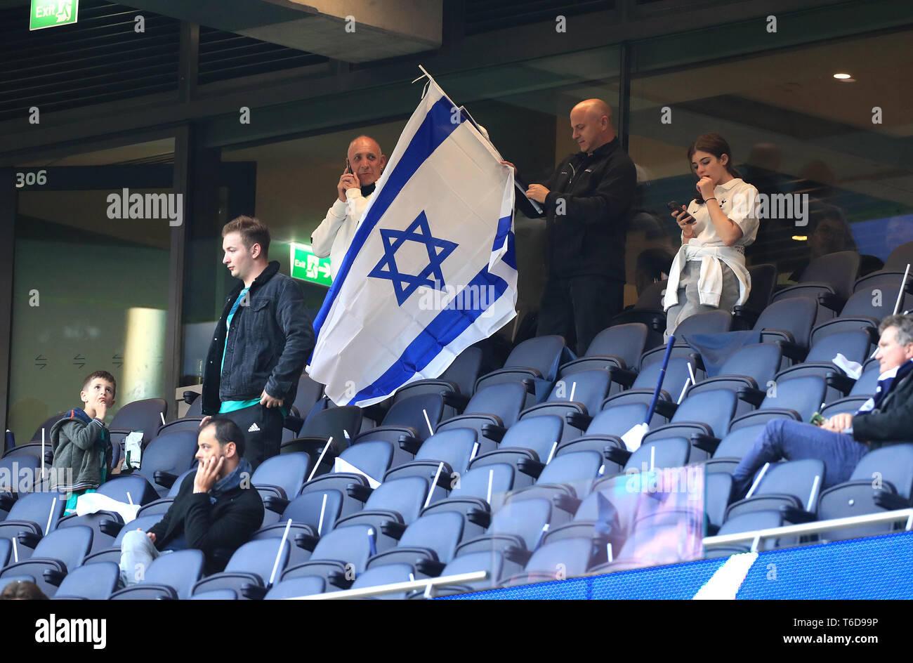 A fan holds a Israel flag in the stands during the Champions League, Semi Final, First Leg at the Tottenham Hotspur Stadium, London. Stock Photo