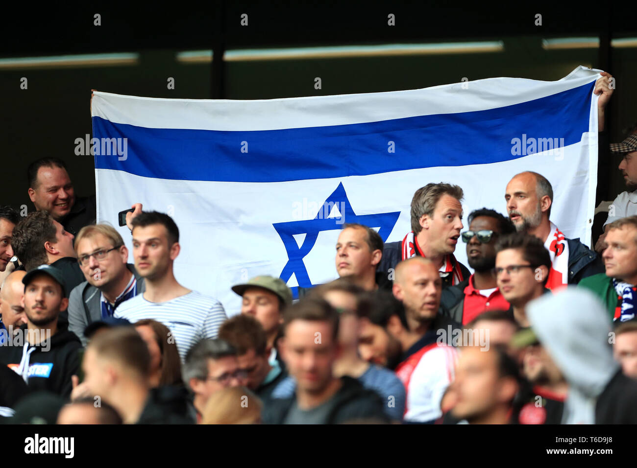 Ajax fans hold a Israel flag in the stands during the Champions League, Semi Final, First Leg at the Tottenham Hotspur Stadium, London. Stock Photo
