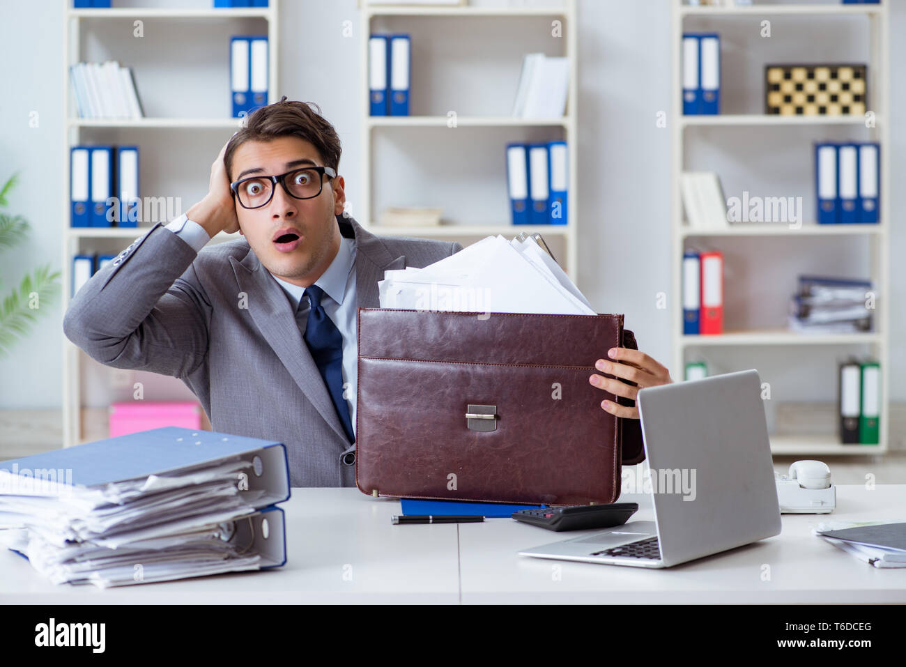 Employee with too much work taking it home Stock Photo - Alamy
