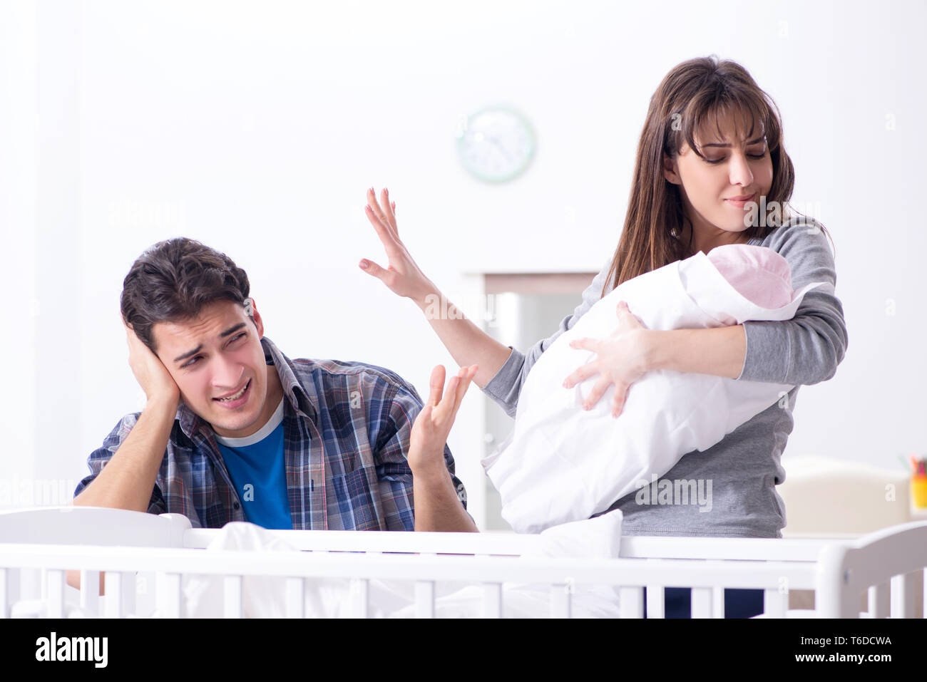 Young dad cannot stand baby crying Stock Photo - Alamy
