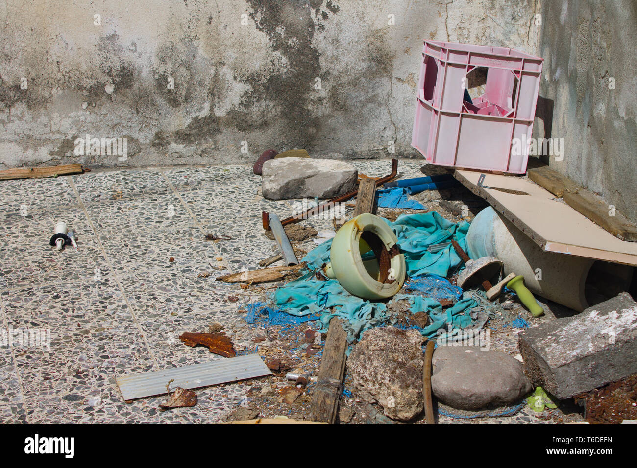 accumulation of garbage near the old house Stock Photo