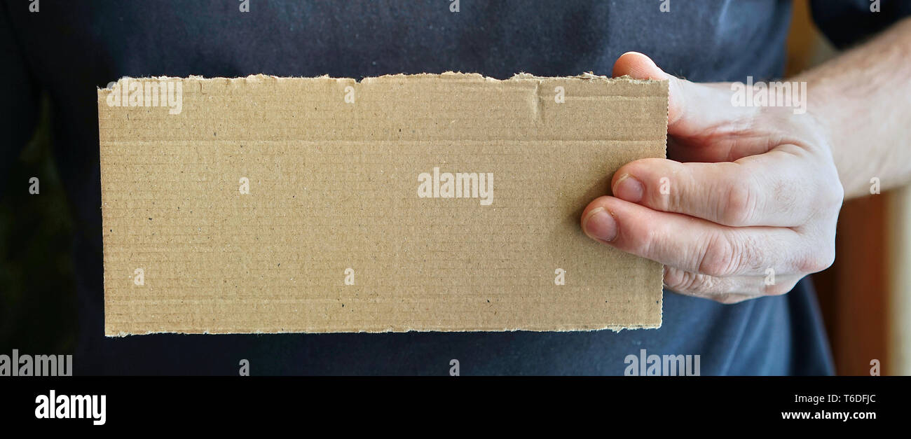 blank sign of cardboard in the hand of a person Stock Photo