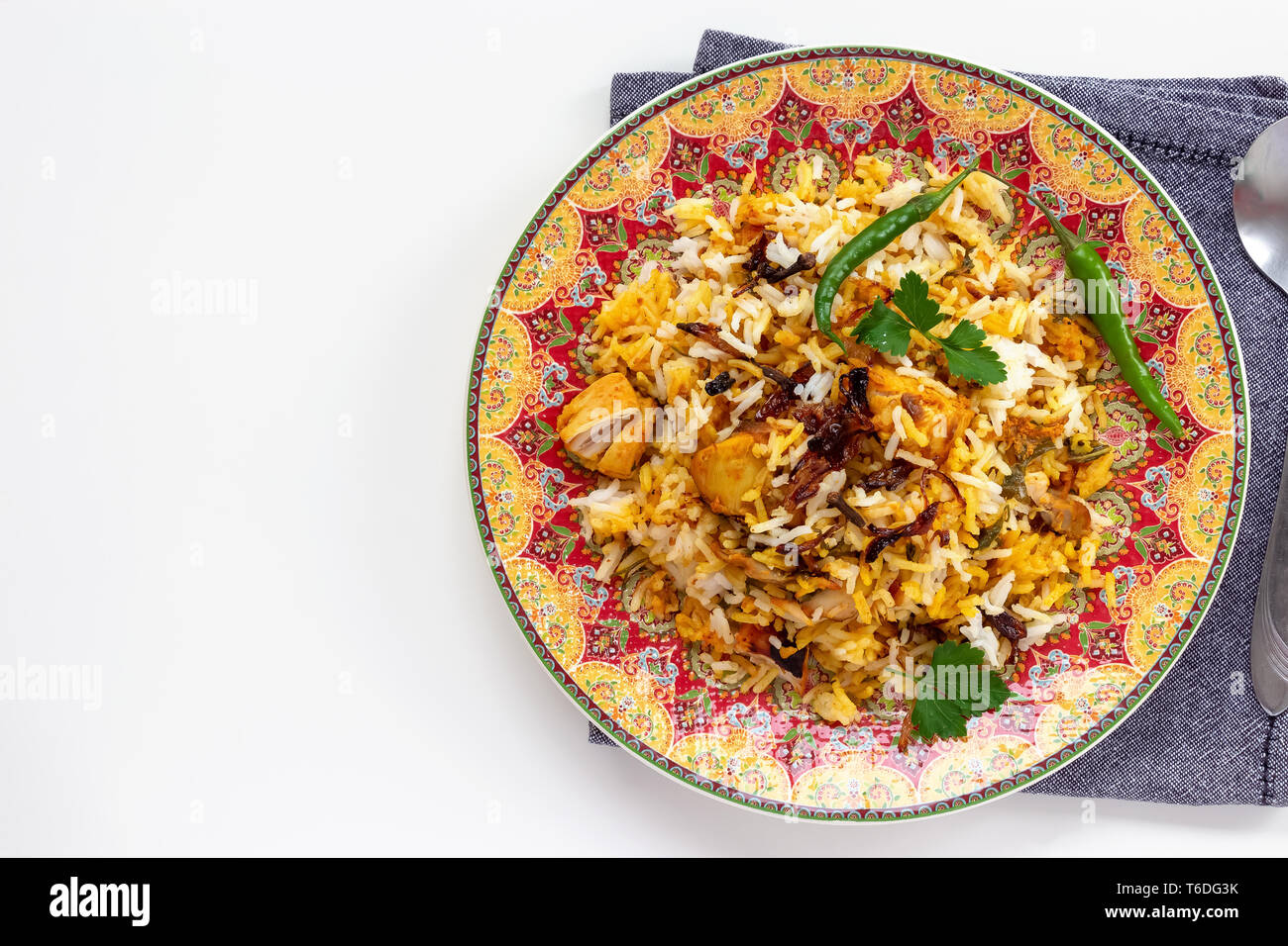 Halal Indian chicken Biryani served with yogurt tomato raita over white