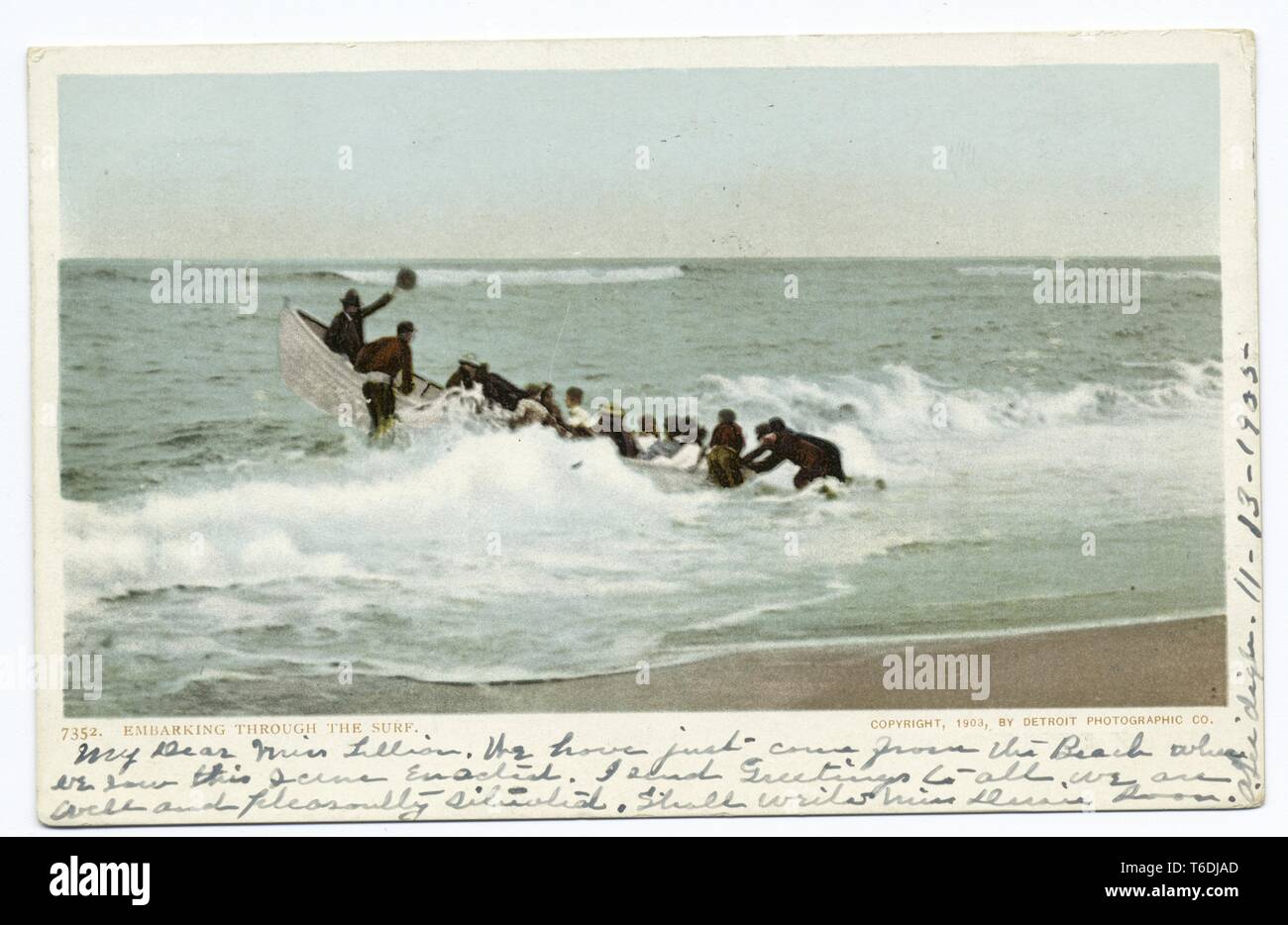 Postcard depicting a group of people launching a small boat from a beach, 1914. From the New York Public Library. () Stock Photo