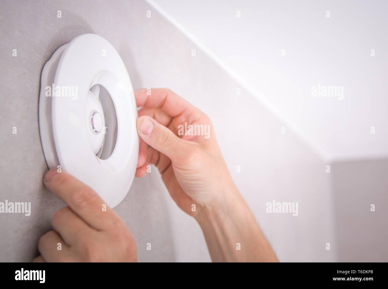 Elegant White Electric Bathroom Vent Installation by Caucasian Men