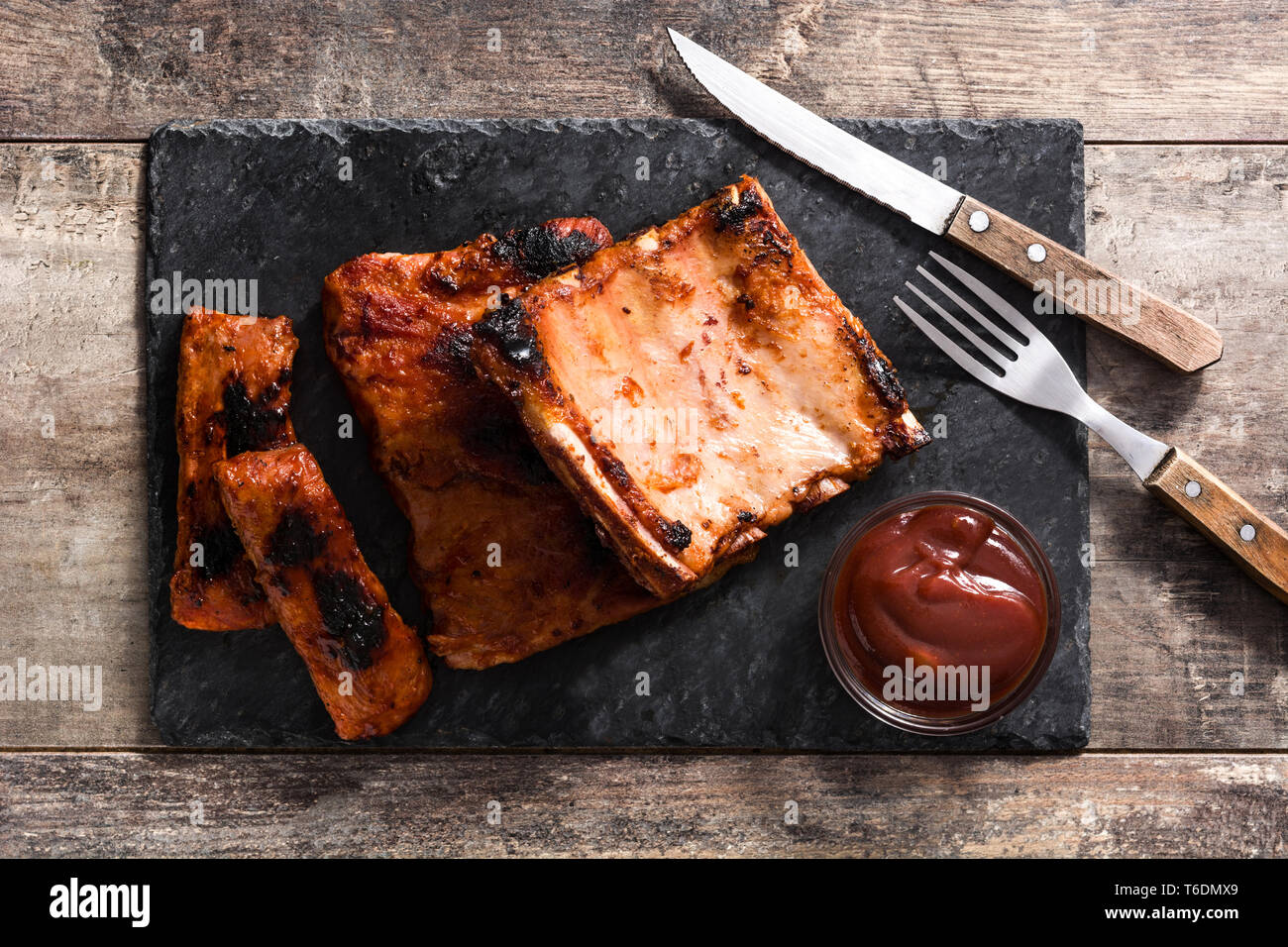Grilled barbecue ribs on wooden table. Top view Stock Photo