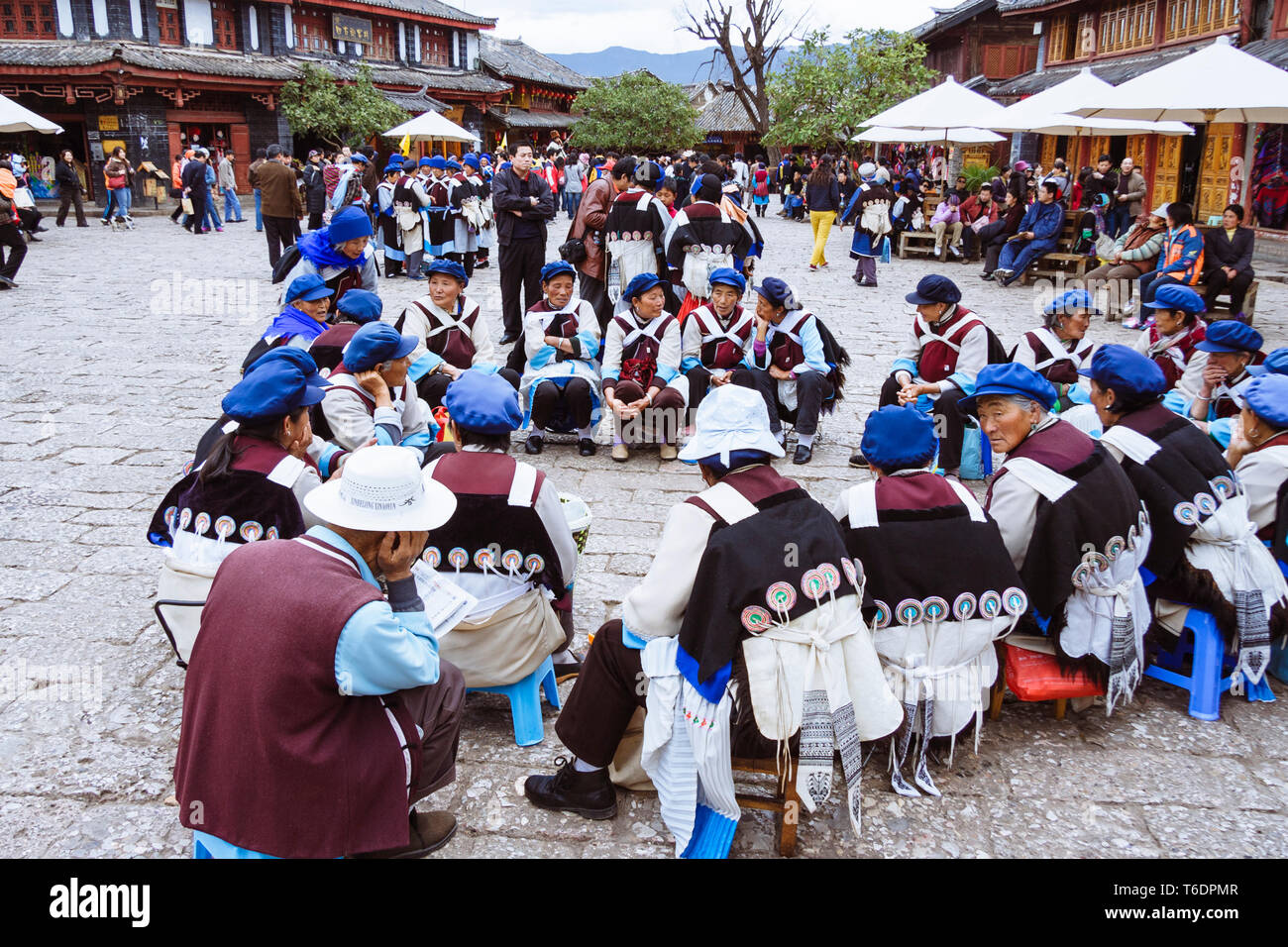 Lijiang Yunnan Province China Naxi Women In Regional Costume Sit At lijiang-yunnan-province-china-naxi-women-in-regional-costume-sit-at