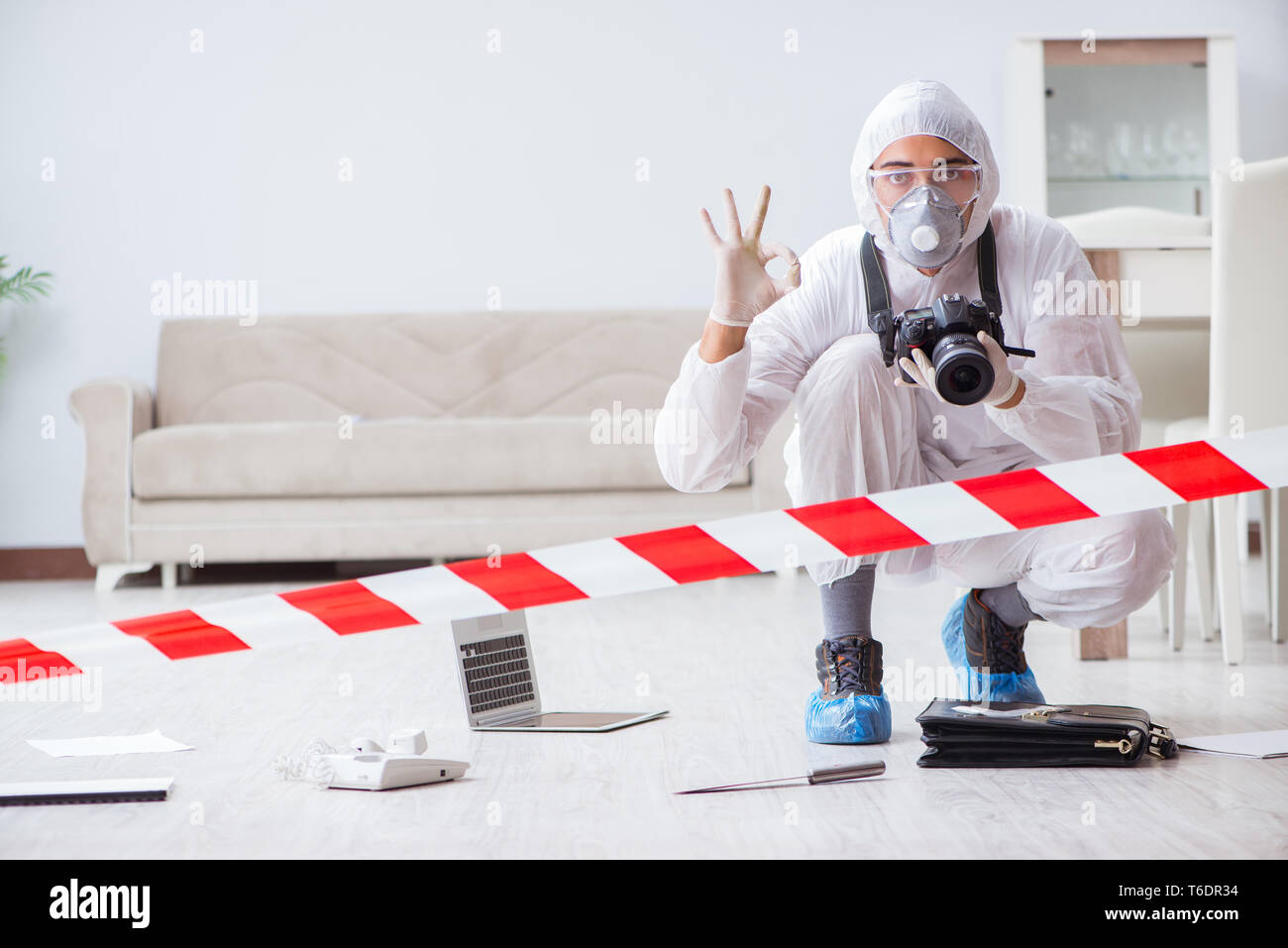 Forensic expert at crime scene doing investigation Stock Photo