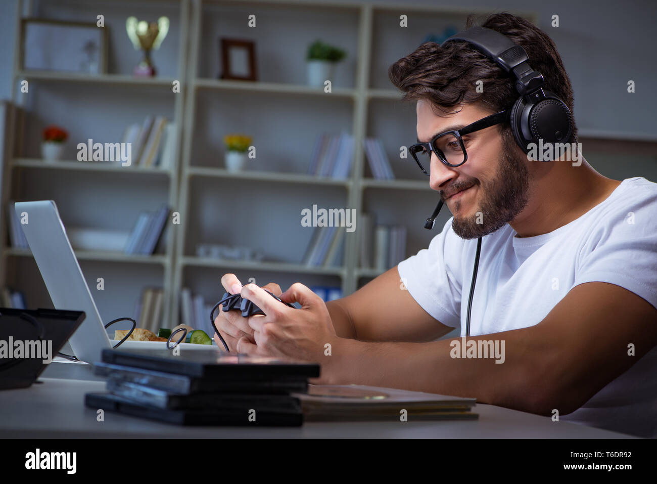 Young man playing games long hours late in the office Stock Photo Alamy