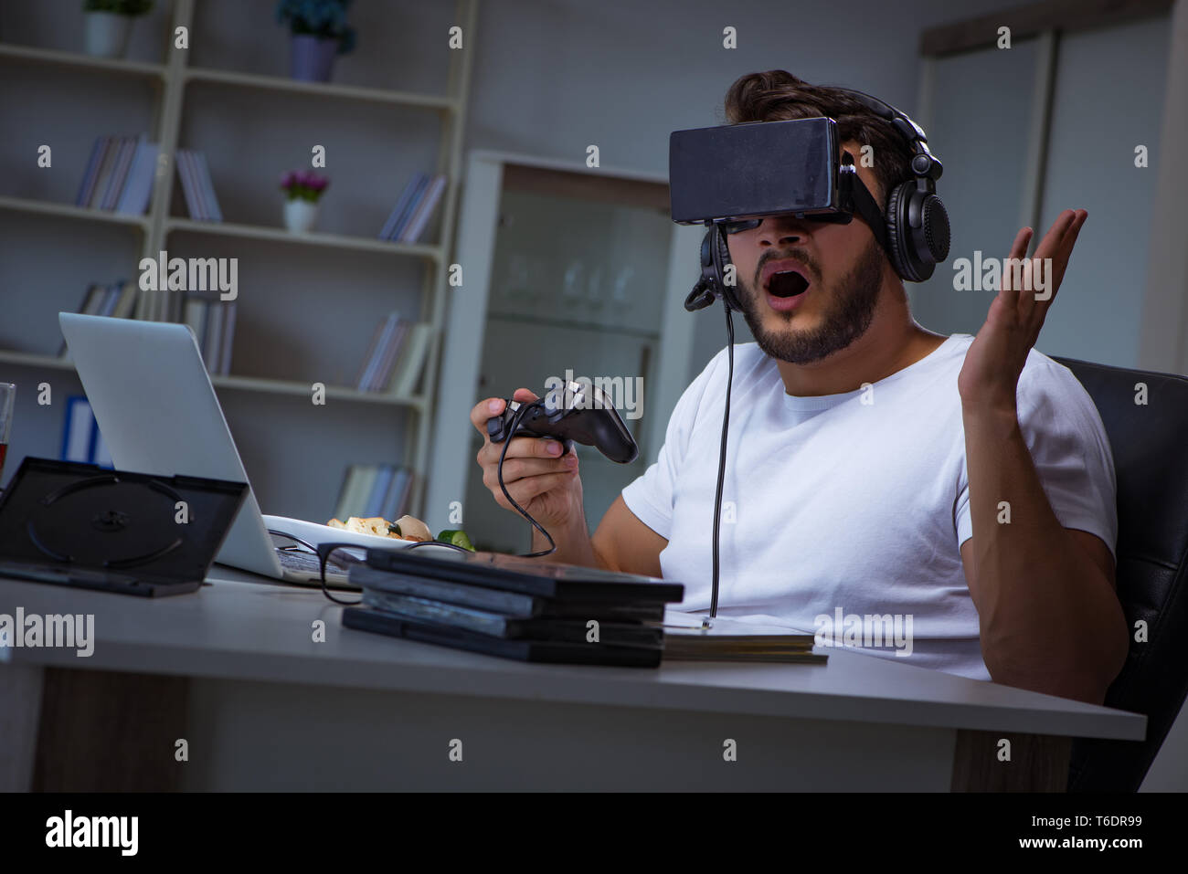 Young man playing games long hours late in the office Stock Photo Alamy