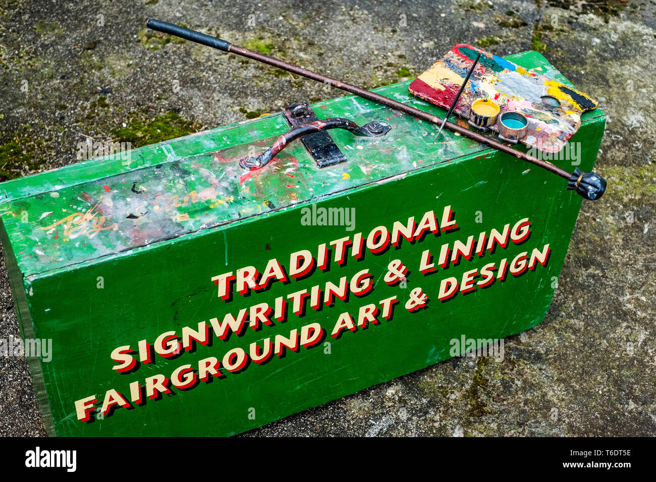 High angle close up of painting materials on green metal toolbox of traditional sign-writer. Stock Photo