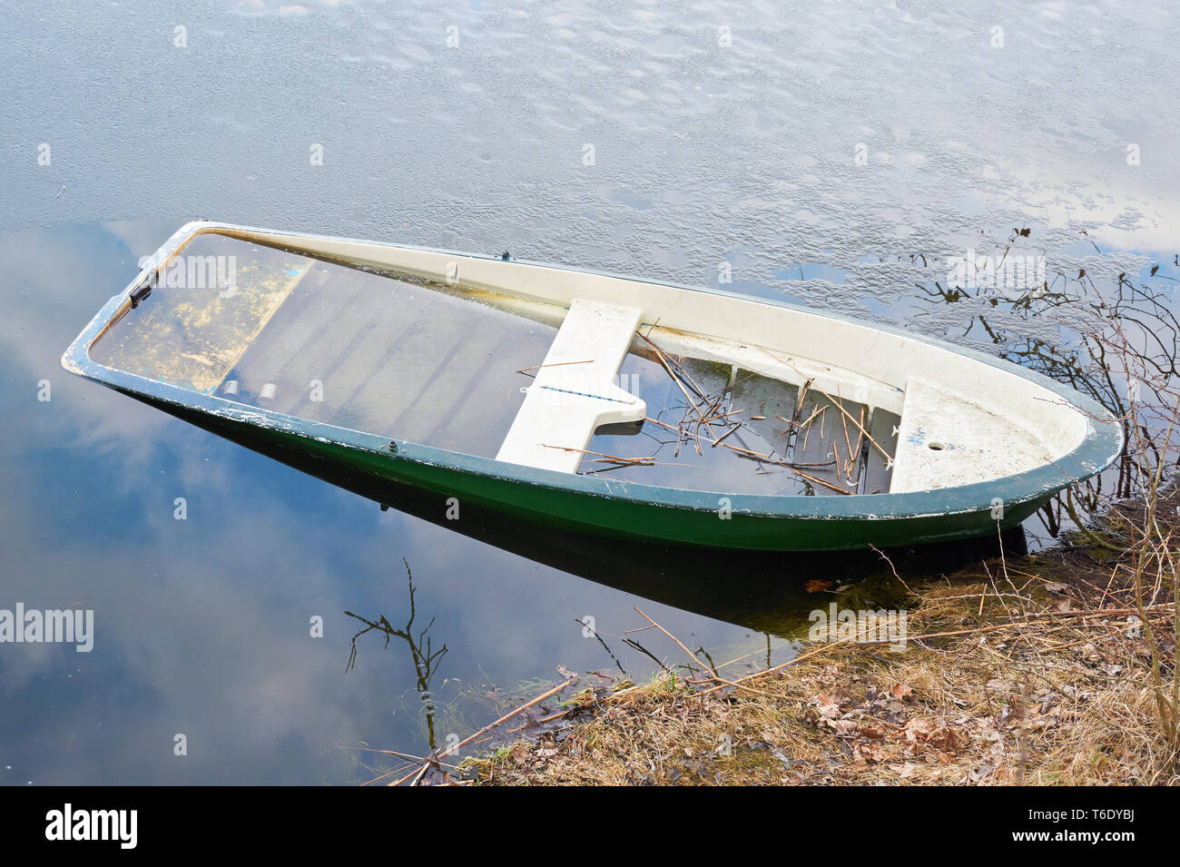 sunken rowing boat in a lake at Magdeburg in Germany Stock Photo