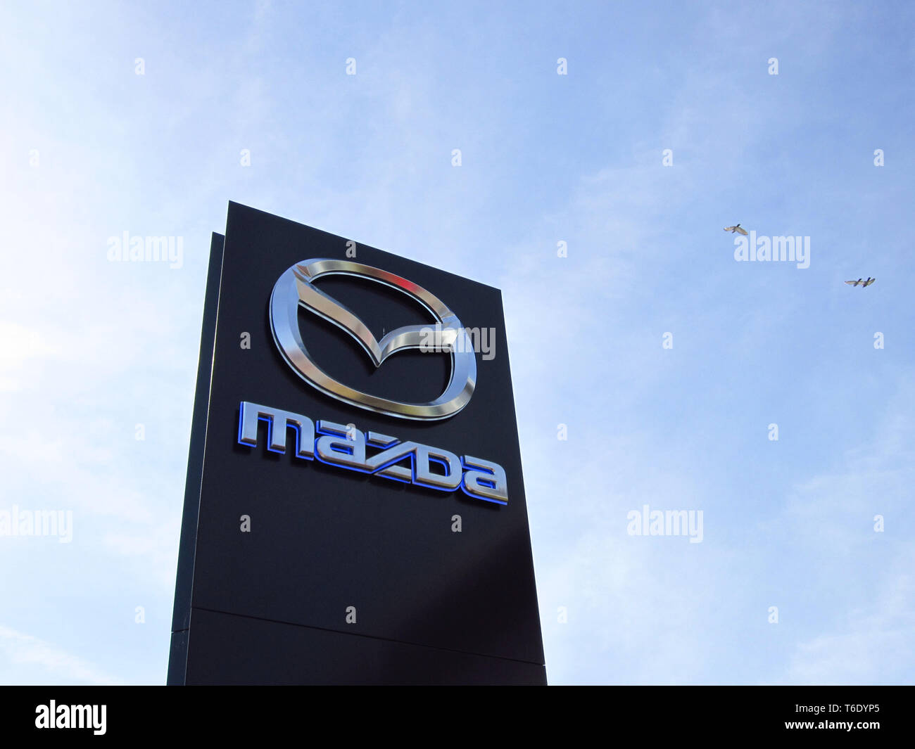 LJUBLJANA, SLOVENIA - MARCH 22 2019: Brand logo at the entrance to Mazda dealership. Mazda is a Japanese multinational car manufacturer. Stock Photo